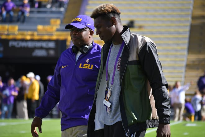 LSU WR coach Mickey Joseph (L) walks 2018 signee Kenan Jones on the field at Tiger Stadium in 2017. (Sam Spiegelman)