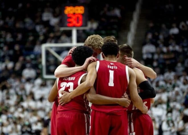 Wisconsin sophomore guard Johnny Davis (1) huddles up with other starting teammates before the Badgers' game at Michigan State.