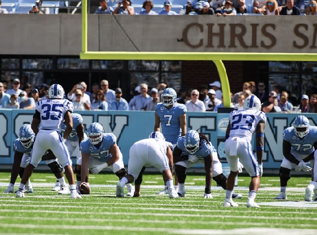 Cayden Baker (57) was the second of three centers to snap the ball to Sam Howell on Saturday.