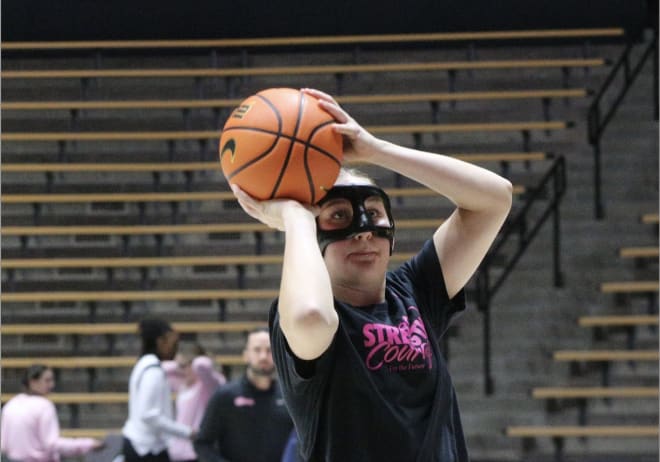 Purdue freshman Mary Ashley Stevenson warms up with a mask to protect her broken nose before playing against Illinois on Monday, Feb. 5, 2024.