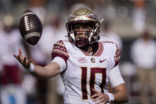 FSU QB McKenzie Milton snares a bad snap earlier this season.