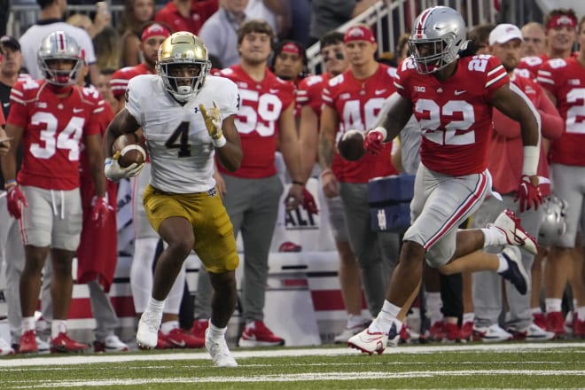 Notre Dame wide receiver Lorenzo Styles (4) catches a pass and runs up the sideline ahead of Ohio State linebacker Steele Chambers (22) during the 2022 season opener, Sept. 3 at Ohio Stadium. 