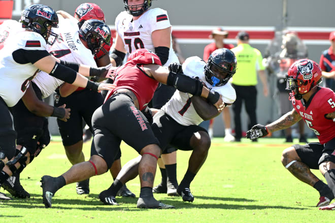 NC State senior defensive end Davin Vann tackles Northern Illinois senior running back Antario Brown last Saturday in Raleigh, N.C.