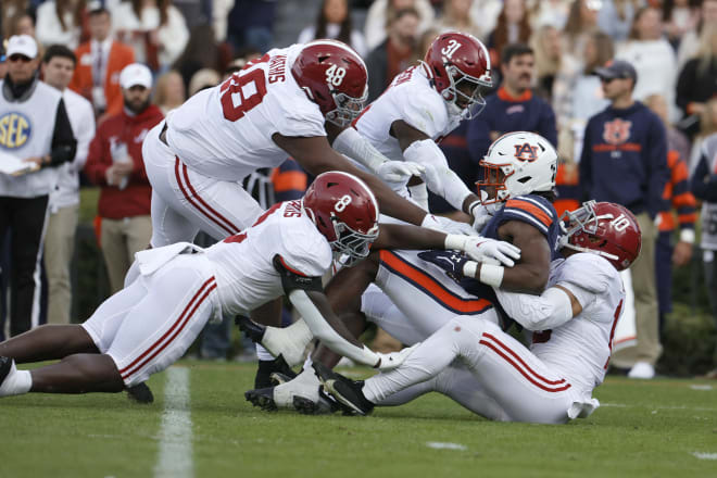Auburn Tigers running back Tank Bigsby (4) is tackled by Alabama Crimson Tide linebacker Henry To'oTo'o (10) and other defenders during the first quarter at Jordan-Hare Stadium. Photo | John Reed-USA TODAY Sports