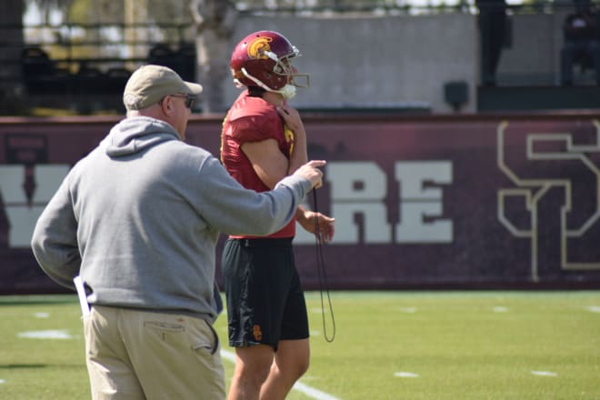 USC special teams coordinator John Baxter gives instruction to new punter Ben Griffiths during practice Thursday.