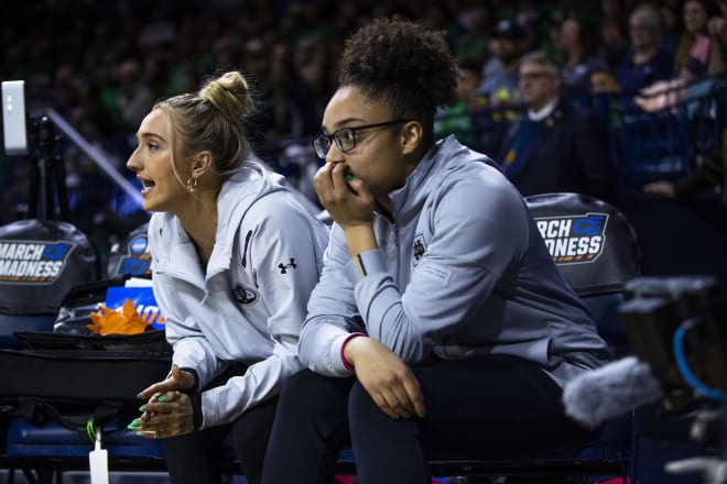 Injured guard Olivia Miles (right), here with Dara Mabrey, deferred her impending knee surgery this week to be with her Notre Dame teammates in Greenville, S.C. this weekend.