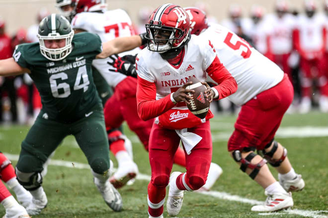 Williams evades pressure from Michigan State defenders during the 2022 matchup between the Hoosiers and Spartans.