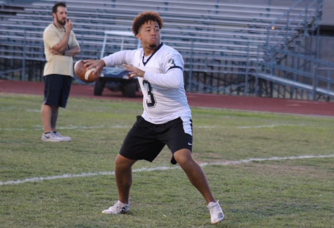 Apollo quarterback Donte Gordon prepares to throw a pass in the Hawks' spring scrimmage on Friday night in Glendale.  Gordon threw TD passes to four different receivers as his Blue team topped the Gold 28-14.