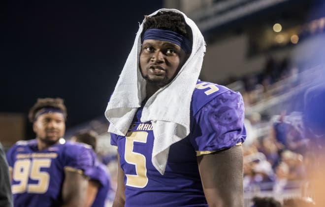 James Madison defensive end Ron'Dell Carter talks with teammates on the side line during the Dukes' win over Morgan State in September at Bridgeforth Stadium.