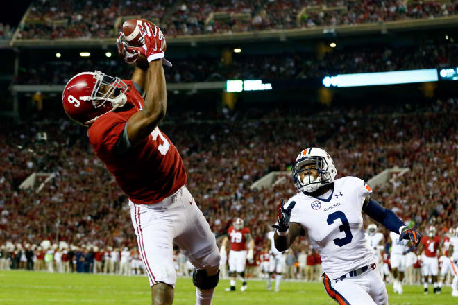 TUSCALOOSA, AL - NOVEMBER 29: Amari Cooper #9 of the Alabama Crimson Tide catches a 17 yard touchdown pass from Blake Sims #6 in the first quarter against Jonathan Jones #3 of the Auburn Tigers during the Iron Bowl at Bryant-Denny Stadium on November 29, 2014 in Tuscaloosa, Alabama. (Photo by Kevin C. Cox/Getty Images)