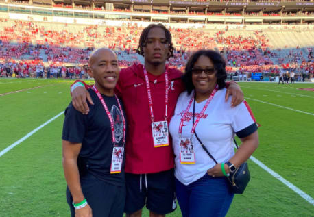 AJ Harris (center) with his father, Daniel, and mother, Glynnis.