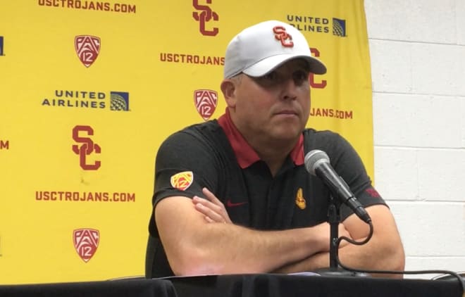 USC coach Clay Helton answers questions Saturday night after the Trojans' 56-24 loss to Oregon.