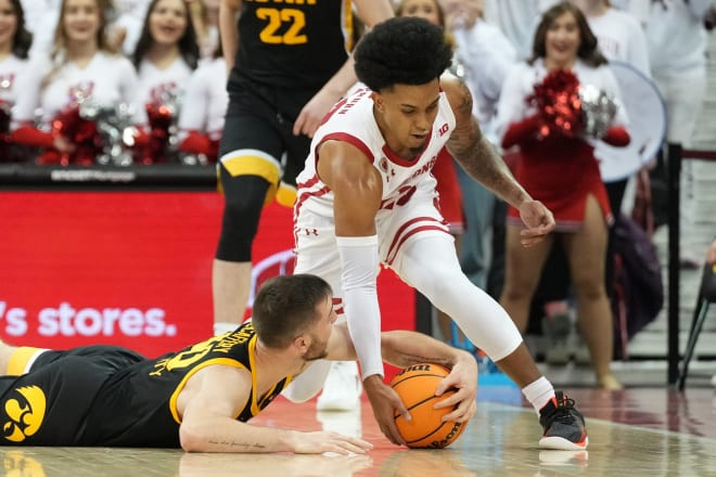 Iowa's Connor McCaffery and Wisconsin's Chucky Hepburn battle for a loose ball in Wisconsin's 64-52 win over Iowa.