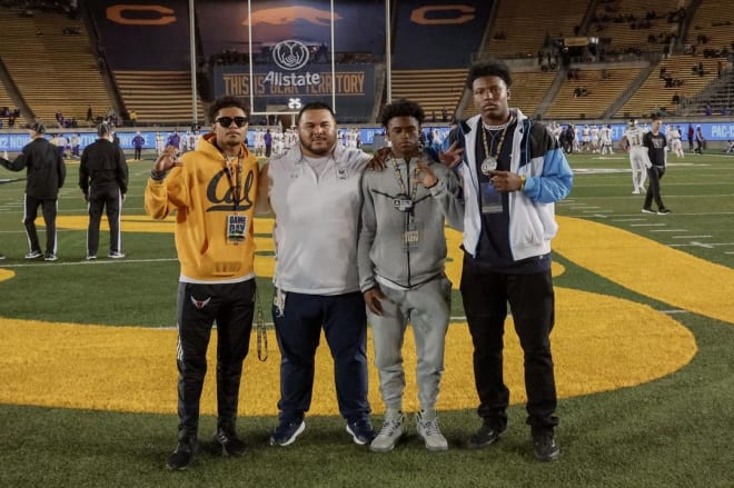 Defensive lineman Frederick Williams III (right) poses with four-star teammate Rodrick Robinson, director of recruiting Benji Palu and current Bears commit Sailasa Vadrawale (left) at California Memorial Stadium on Saturday.