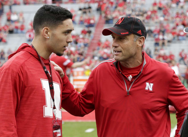 Mike Riley chats with recruiting prospect Talanoa Hufanga at Nebraska's spring game.