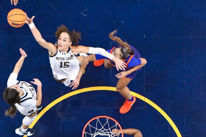 Notre Dame senior Nat Marshall (15) reaches for a rebound Thursday night during a 74-47 Irish romp over Clemson.