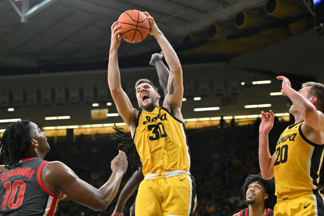 Connor McCaffery hauls down a rebound in Iowa's 92-75 win over Ohio State. 