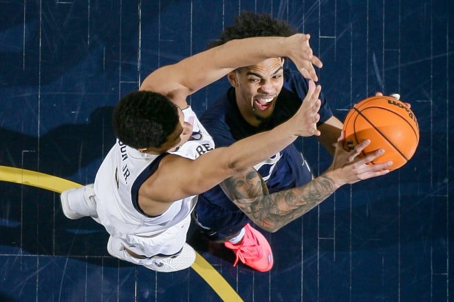 Georgia Tech guard Michael Devoe (0) looks to shoot as Notre Dame forward Paul Atkinson Jr. (20) defends, Saturday at Purcell Pavilion in South Bend, Ind.