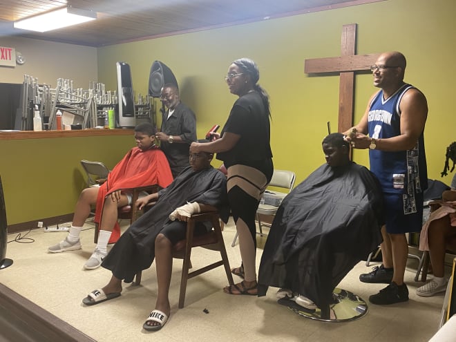 Barbers give free haircuts to students at Darius Robinson's back to school drive
