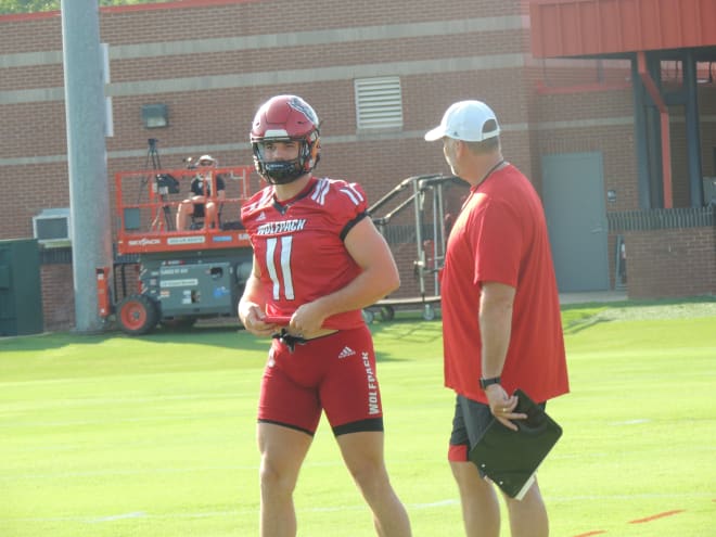 NC State redshirt junior outside linebacker Payton Wilson is greeted by Wolfpack coach Dave Doeren at the start of practice Wednesday.