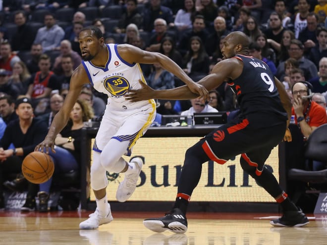 Golden State's Kevin Durant drives past Toronto's Serge Ibaka during the Warriors' win over the Raptors Saturday.