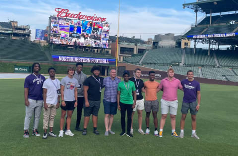 Charles Anderson Jr. (fourth from left) and the rest of the official visitors at Wrigley Field.