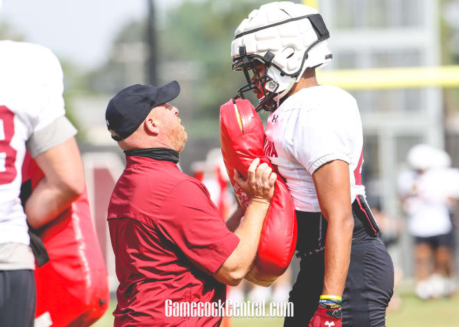 South Carolina tight ends coach Erik Kimrey demonstrates a blocking drill in a spring practice.