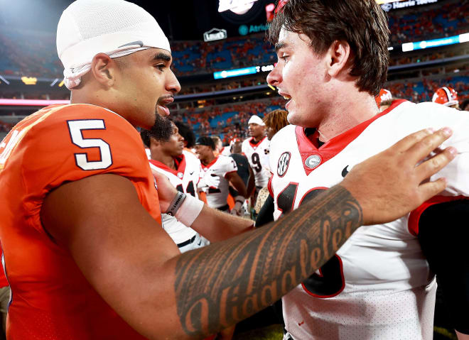 Clemson quarterback D.J. Uiagalelei has a brief exchange with UGA quarterback J.T. Daniels following Saturday night's top five clash in Charlotte.