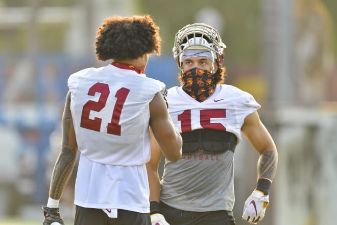 Starting safeties Isaiah Pola-Mao (21) and Talanoa Hufanga (15) talk at practice Friday.