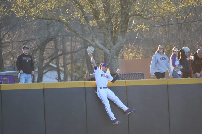 Andrew Henrickson skies over the left field wall to rob Maryland of a sure home run in ECU's 4-0 victory.