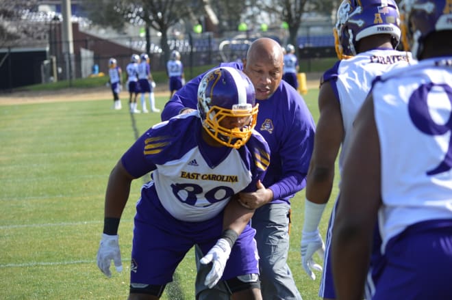 New ECU defensive line coach Robert Prunty works with Raequan Purvis on Tuesday at Hight Field.