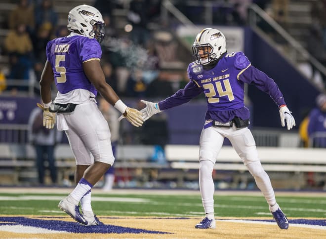 James Madison defensive end Ron'Dell Carter (5) celebrates with safety D'Angelo Amos during the Dukes' semifinal win over Weber State last month at Bridgeforth Stadium in Harrisonburg.