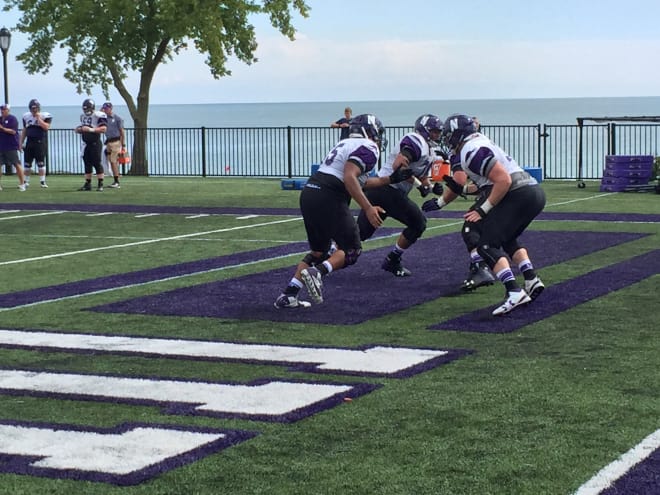 Members of Northwestern's offensive line go through drills during Friday's practice.