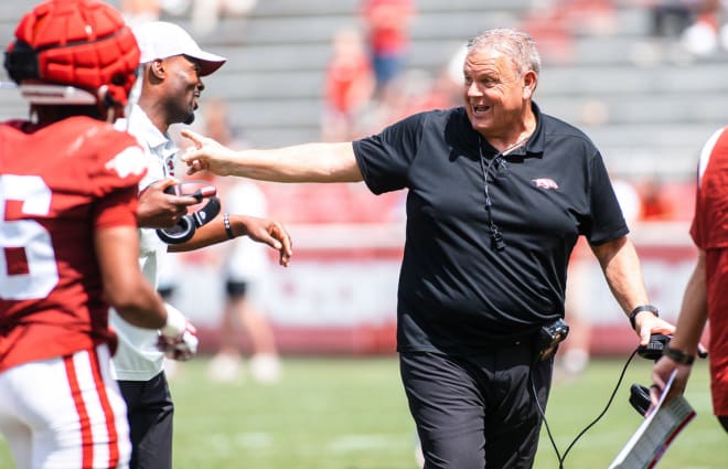 Arkansas head coach Sam Pittman talks with defensive coordinator Travis Williams during the Razorbacks' Red-White spring scrimmage.