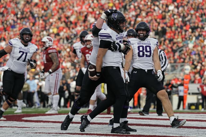Nov 11, 2023; Madison, Wisconsin, USA; Northwestern Wildcats quarterback Ben Bryant (2) celebrates after scoring a touchdown during the second quarter against the Wisconsin Badgers at Camp Randall Stadium. Mandatory Credit: Jeff Hanisch-USA TODAY Sports