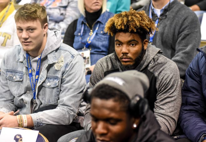 Sear (left, in jean jacket) on his official visit