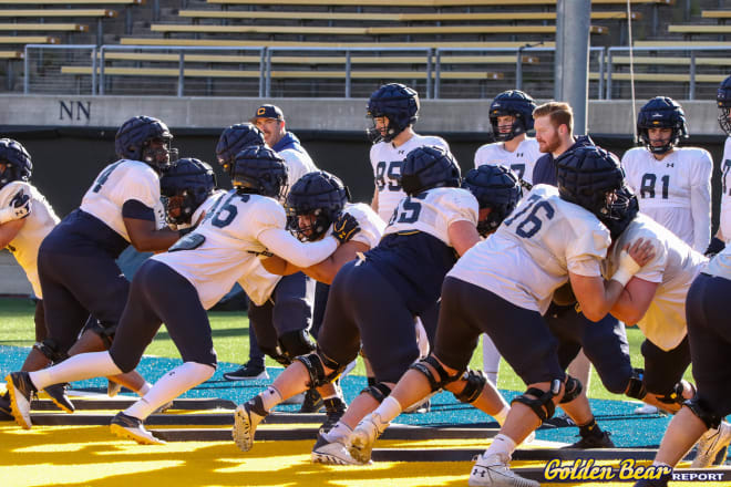 Mike Saffell (center) watches over the Cal offensive line during spring practice.