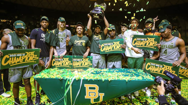 Baylor players hold the Big 12 championship trophy Sunday after beating Texas Tech, 88-73.