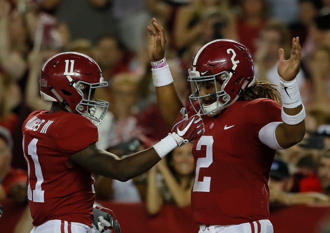 Alabama receiver Henry Ruggs III (11) celebrates with quarterback Jalen Hurts after a touchdown. Photo | Getty Images
