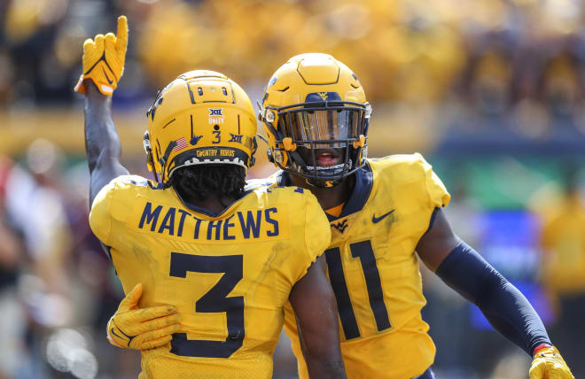est Virginia Mountaineers cornerbacks Jackie Matthews (3) and Nicktroy Fortune (11) celebrate after a stop late in the fourth quarter against the Virginia Tech Hokies at Mountaineer Field at Milan Puskar Stadium. 