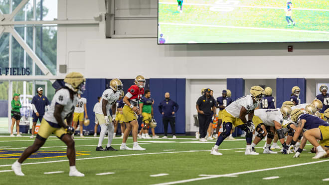 Notre Dame quarterback Riley Leonard, in red, has led the Irish offense to a clean operation, according to head coach Marcus Freeman