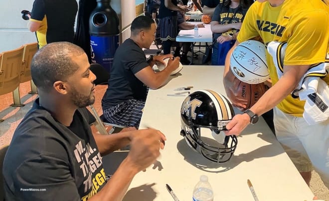 Smith and Corby Jones sign autographs for Mizzou fans at an alumni basketball game in July