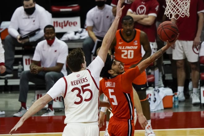 Illinois's Andre Curbelo drives past Wisconsin's Nate Reuvers during the Illini's 74-69 victory at the Kohl Center Saturday.