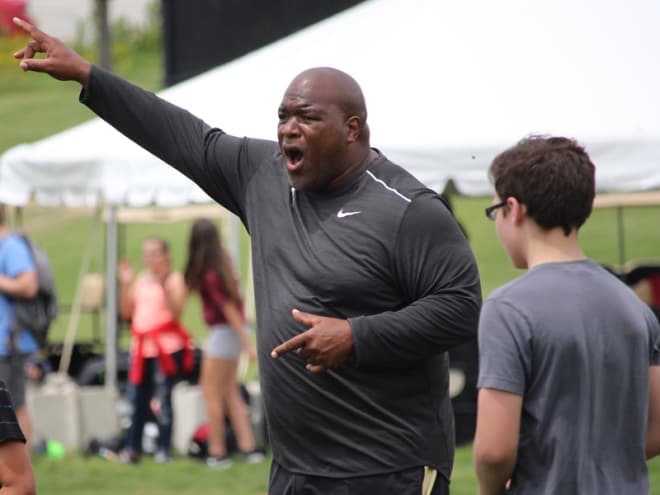 Defensive line coach Reggie Johnson smiled often during the second session of PALS camp, but he also was quick to direct.