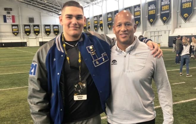 Class of 2021 defensive end Gabriel Rubio with Iowa assistant coach LeVar Woods.