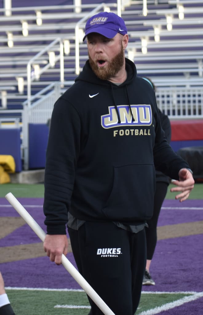 James Madison defensive coordinator Corey Hetherman instructs a drill at Dukes spring practice earlier this month at Bridgeforth Stadium.