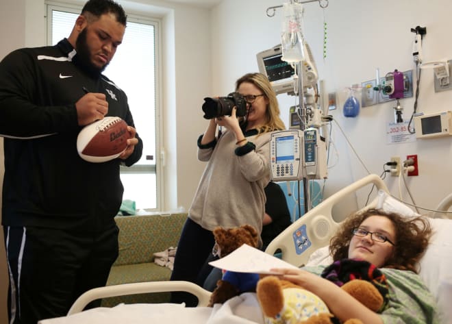Hyde visiting a children's hospital prior to UK's bowl game last year. Photo by UK Athletics. 