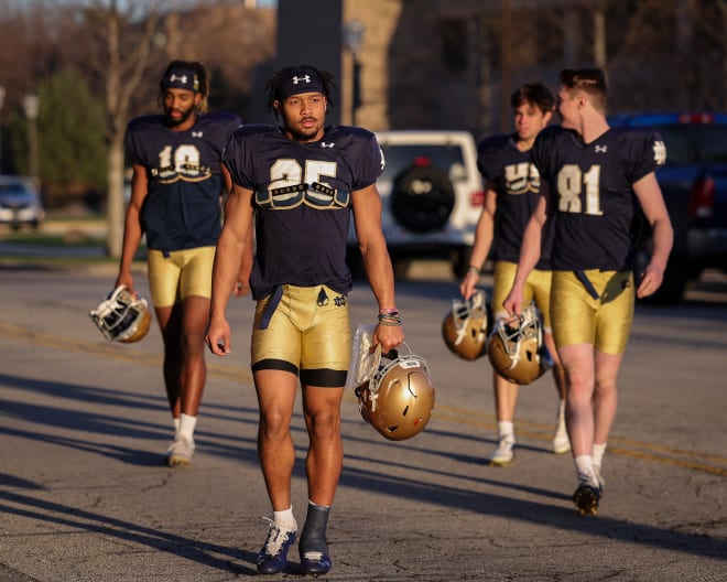 Chris Tyree (25) heads to Notre Dame spring practice last week with his left ankle heavily taped.