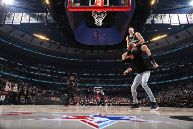 Former Notre Dame guard Pat Connaughton dunking over 6-11 teammate Giannis Antetokounmpo in the NBA Dunk Contest (photo Courtesy of the NBA)