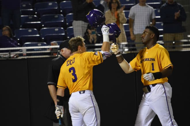 Dwanya Williams-Sutton taps hats with Charlie Yorgen after cracking one of two homers for ECU.